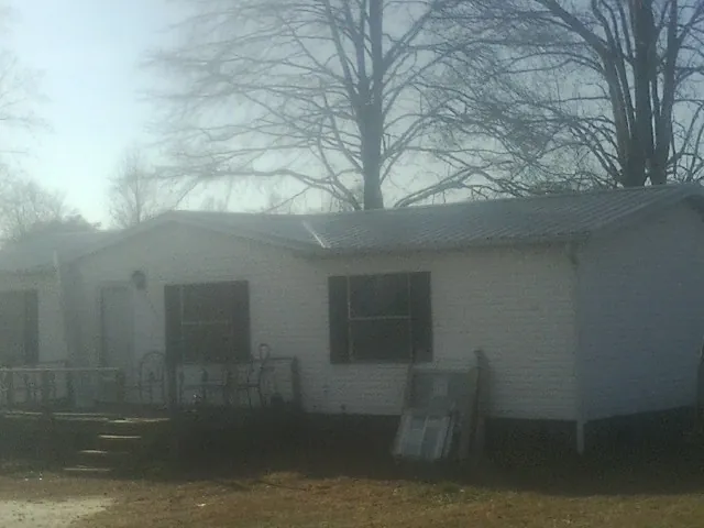 New metal roof on a white painted brick home on a foggy morning in Rolling Meadows