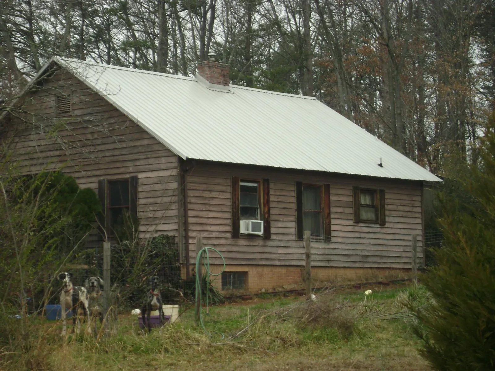 White metal roof on an old wood sided farmhouse, from a Metal Roof Installation job in Rolling Meadows